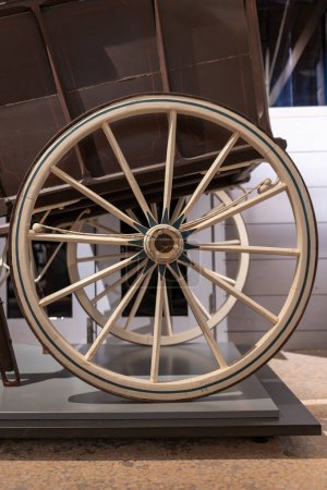 Close up of a wooden cart wheel on an antique horse drawn cart