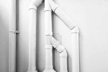 Photo for White Pipes on Concrete Wall with Light Beam and Shadow. - Royalty Free Image