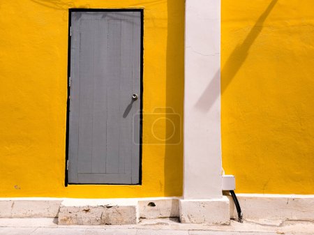 Téléchargez les photos : Porte en bois vert avec fond mural en béton jaune. - en image libre de droit