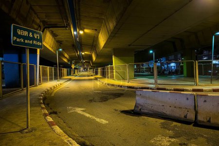 Photo for Scenery of Under Overpass Bridge at Night. (Translation Thai Text on Sign is "Park and Ride") - Royalty Free Image