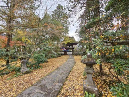 Foto de YUFUIN, JAPÓN - 12 de noviembre de 2023: Camino en el Templo de Bussanji. Su puerta del templo es enorme y tiene un techo de paja. Es un hito de Yufuin. - Imagen libre de derechos