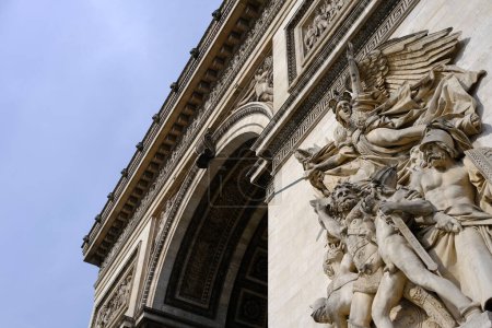 Photo for Paris, France - August 30, 2022: Ancient sculpture on Paris's Arc de Triomphe in the cloudy day where is a famous landmark of Paris, France. - Royalty Free Image