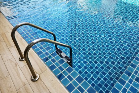 Photo for Stainless steel swimming pool ladder. - Royalty Free Image