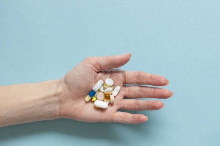 Photo for Hands of woman holding pills. Seasonal affective disorder concept. - Royalty Free Image