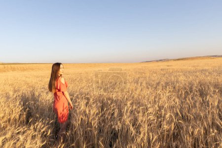 Photo for Young woman in the wheat field, mental and physical wellbeing concept. Copy space. - Royalty Free Image