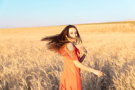 Photo for Young woman in the wheat field. Look back. Finding inner balance concept. Copy space - Royalty Free Image