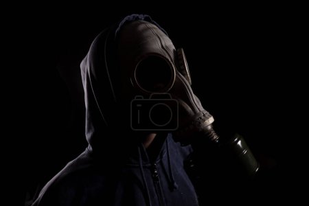 Photo for Man in a gas mask, the concept of air pollution, the environment with chemicals - Royalty Free Image