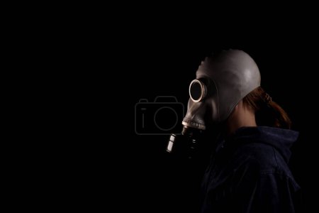 Photo for Woman in a gas mask, the concept of air pollution, the environment with chemicals - Royalty Free Image