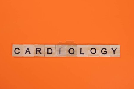 Foto de Palabra de cardiología de letras de madera sobre fondo naranja - Imagen libre de derechos