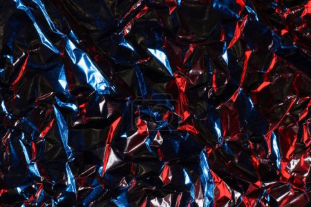 crumpled aluminum foil in red and blue light, background or texture Poster 655264540
