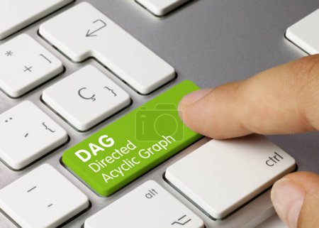 DAG Directed Acyclic Graph Written on Green Key of Metallic Keyboard. Finger pressing key.
