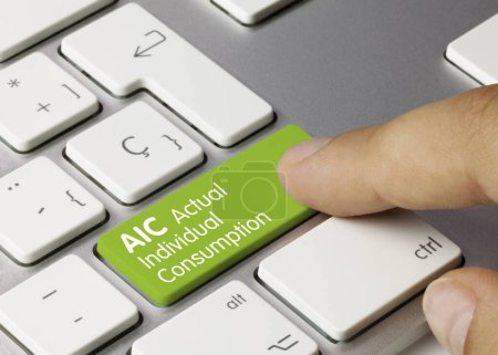 AIC Actual Individual Consumption Written on Green Key of Metallic Keyboard. Finger pressing key.
