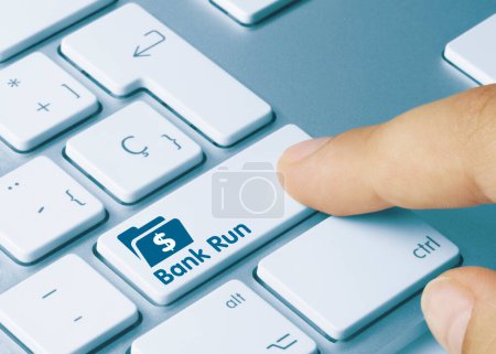 Bank Run Written on Blue Key of Metallic Keyboard. Finger pressing key.