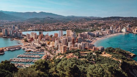 Panorama of the city of Calpe, province of Alicante, seen from the Penon de Ifach. Summer holidays in Costa Blanca. Beaches and port with boats and yachts. Travel, hiking, sea vacation concept
