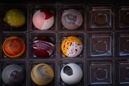 Photo for Close up of selection of colorful sweet delicious round shape chocolates in a box - Royalty Free Image