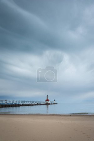 Photo for Storm clouds approaching St. Joseph lighthouse and beach.  St. Joseph, Michigan, USA. - Royalty Free Image