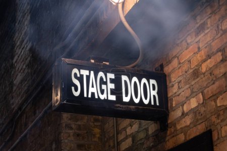 Photo for Vintage illuminated stage door sign in a dark and dingy back alley in the city of Chicago, Illinois, USA - Royalty Free Image