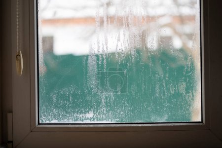 Photo for Condensation droplets on plastic window glass from temperature changes. - Royalty Free Image