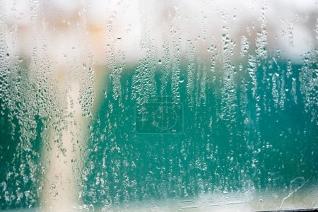 Kondensationstropfen auf Kunststoff-Fensterglas durch Temperaturänderungen. 