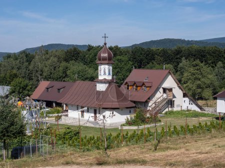 Photo for Bumbesti-Jiu, Gorj, Romania  July 29, 2023: The church and hermitage of St. John the Baptizer, at the foothill of the mountain Parang. It is a hermitage of old rite Christian monks. - Royalty Free Image