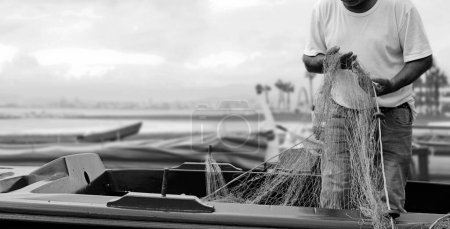 Foto de Pescador malagueño con redes en las manos en las playas del palo, se prepara para la pesca - Imagen libre de derechos