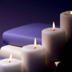 candles and books with purple background