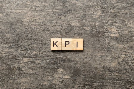 Photo for Kpi word written on wood block. key performance indicators text on table, concept. - Royalty Free Image