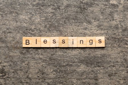 Blessings word written on wood block. Blessings text on cement table for your desing, Top view concept.