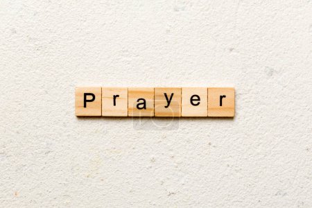 Photo for PRAYER word written on wood block. PRAYER text on cement table for your desing, concept. - Royalty Free Image