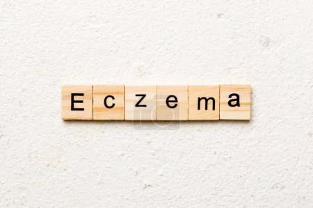 eczema word written on wood block. eczema text on table, concept.