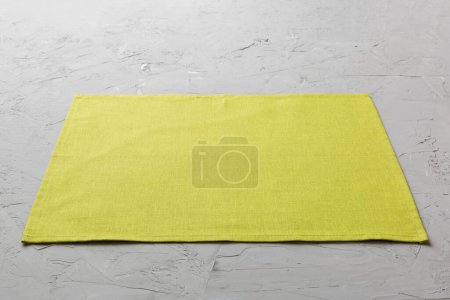 Photo for Perspective view of green tablecloth for food on cement background. Empty space for your design. - Royalty Free Image
