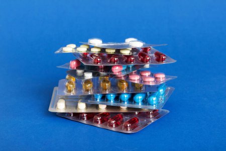 Photo for Too many different pill cartridges stacked. selective Focus. Packs of blister pills with tablets. Colored pastilles packages. A pile of medicine in blister packs. Pharmaceutical blister packs. - Royalty Free Image