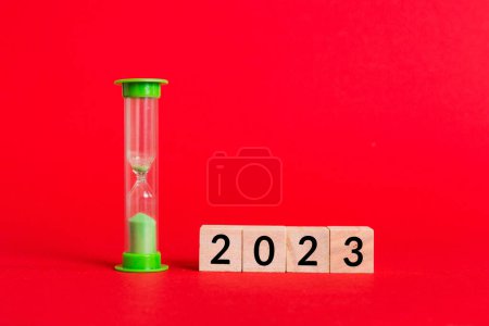 Photo for New Year 2023 sand timer. Resolution, time, plan, goal, motivation, reboot, countdown and New Year holiday concepts. Hourglass with number 2023. - Royalty Free Image