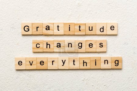 Dankbarkeit verändert alles, was auf Holzklötzen geschrieben steht. Dankbarkeit verändert alles, was auf dem Tisch steht, für Ihre Gestaltung, Ihr Konzept.