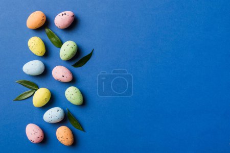 Happy Easter concept. Preparation for holiday. Easter eggs on colored background. flat lay top view copy space banner.