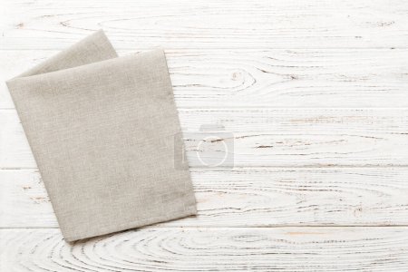 Photo for Top view with gray kitchen napkin isolated on table background. Folded cloth for mockup with copy space, Flat lay. Minimal style. - Royalty Free Image