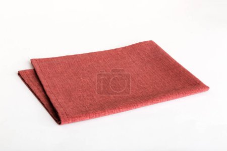 Photo for Top view with red empty kitchen napkin isolated on table background. Folded cloth for mockup with copy space, Flat lay. Minimal style. - Royalty Free Image