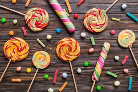 Photo for Tasty appetizing Party Accessories Happy Birthday Sweet. Different types of candies on colored background, copy space. Colorful birthday party background. - Royalty Free Image