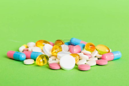 Foto de Many different colorful medication and pills perspective view. Set of many pills on colored background. - Imagen libre de derechos
