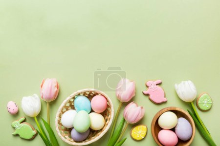 Photo for Easter frame with eggs, gift box and tulip on a colored background. The minimal concept. Top view Happy Easter composition. Card with a copy space of the place for the text. - Royalty Free Image