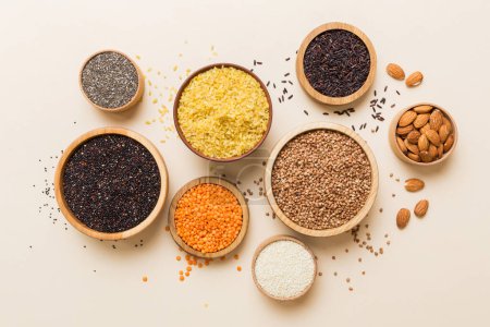 Photo for Various superfoods in smal bowl on colored background. Superfood as rice, chia, quinoa, lentils, nuts, sesame seeds, almonds. top view copy space. - Royalty Free Image