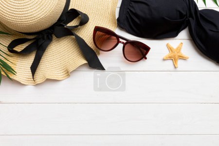 Photo for Woman swimwear and beach accessories flat lay top view on colored background Summer travel concept. bikini swimsuit, straw hat and seasheels. Copy space Top view. - Royalty Free Image