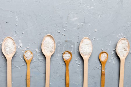 Photo for Salt on many wooden spoon on wood background. Spoons with different salt. - Royalty Free Image