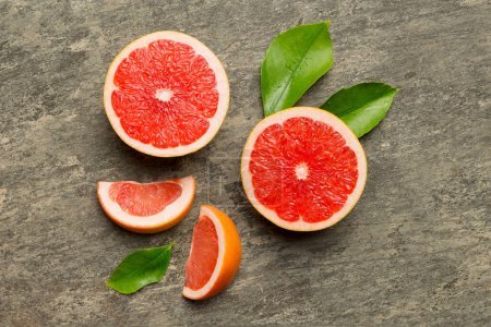 Photo for Fresh Fruit grapefruit with Juicy grapefruit slices on colored background. Top view. Copy Space. creative summer concept. Half of citrus in minimal flat lay with copy space. - Royalty Free Image