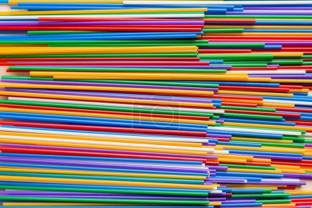 Photo for Many multi-colored plastic tubes for cocktail on Colored background, top view. - Royalty Free Image
