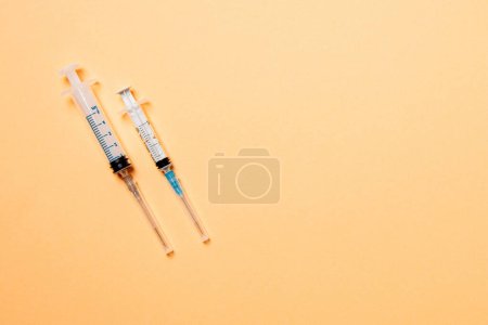 Photo for Top view of medical syringes on colorful background with copy space. Injection equipment concept. - Royalty Free Image