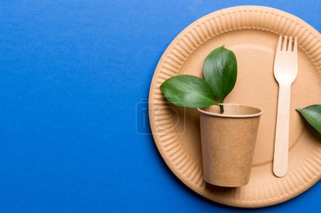 Photo for Set of empty reusable disposable eco-friendly plates, cups, utensils on light white colored table background. top view. Biodegradable craft dishes. Recycling concept. Close-up. - Royalty Free Image