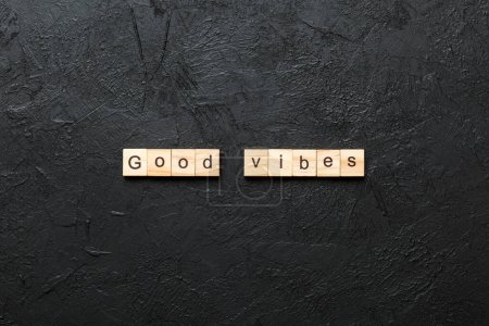good vibes word written on wood block. good vibes text on table, concept.