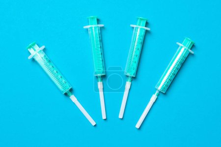 Photo for Top view of medical syringes on colorful background with copy space. Injection equipment concept. - Royalty Free Image