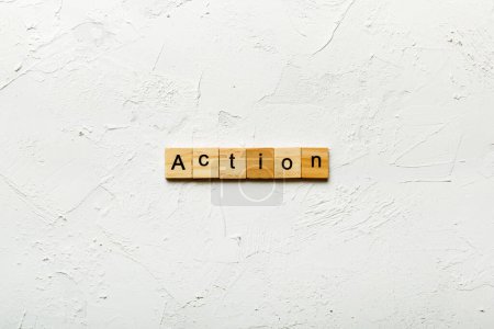 Action word written on wood block. Action text on table, concept.